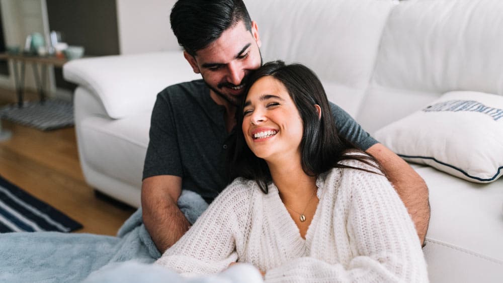 https://waterlooenergy.com/wp-content/uploads/2023/08/smiling-young-couple-loving-each-other-near-sofa-1.jpg